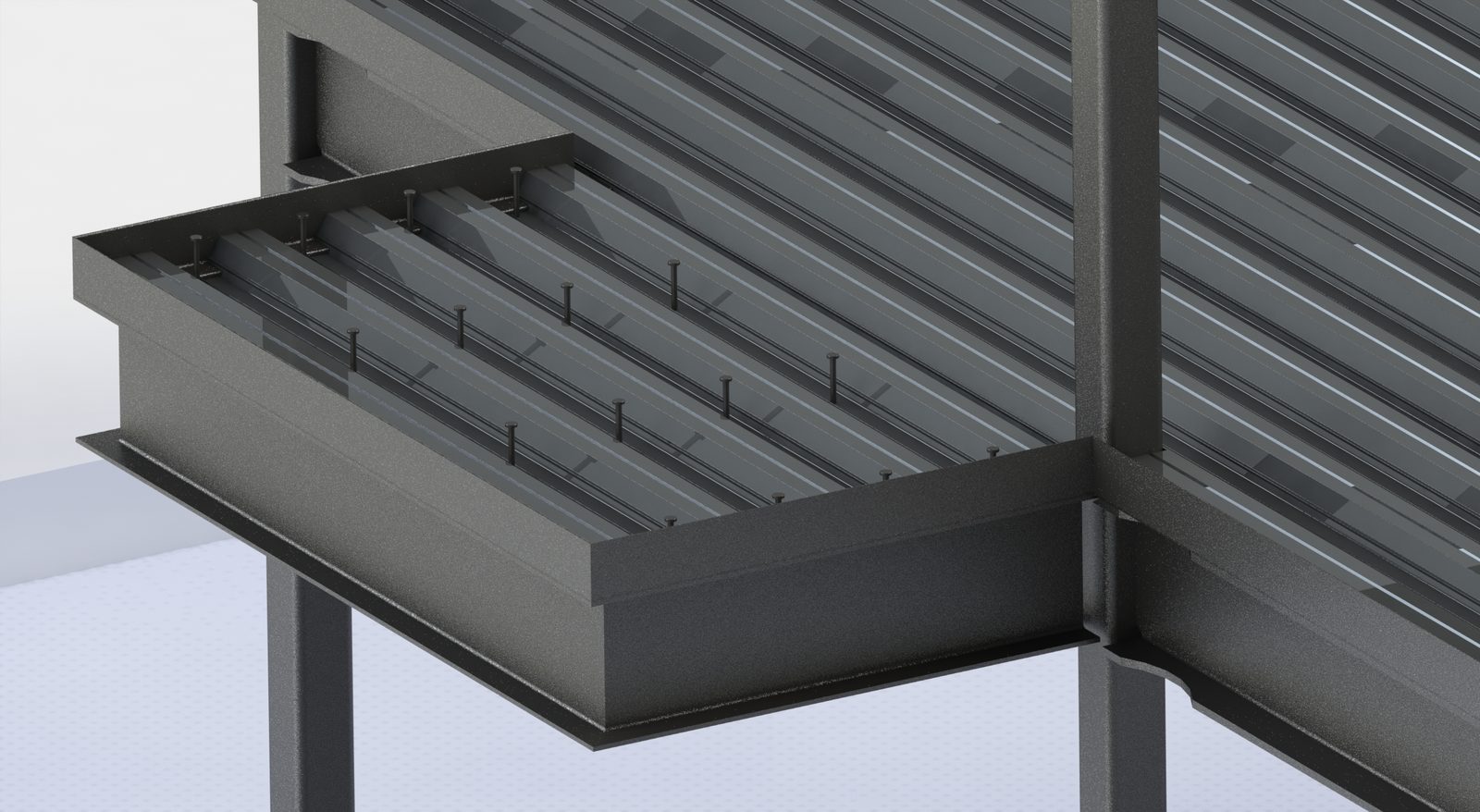 Close-up of composite pan deck with shear studs at the beam edge
